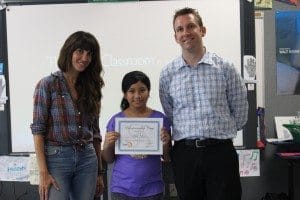 Ryan Holbrook and entrepreneur Katrina Salazar award attendee Jaylin V. her certificate.
